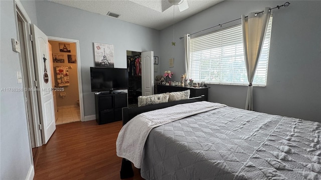 12222 SW 148th St, Miami, FL 33186 - bedroom featuring a textured ceiling, visible vents, dark wood-style floors, a closet, and baseboards