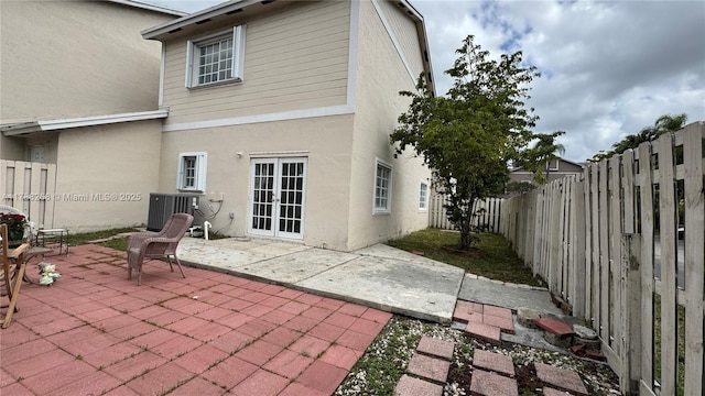 12222 SW 148th St, Miami, FL 33186 - back of property with central AC unit, stucco siding, a fenced backyard, and a patio area