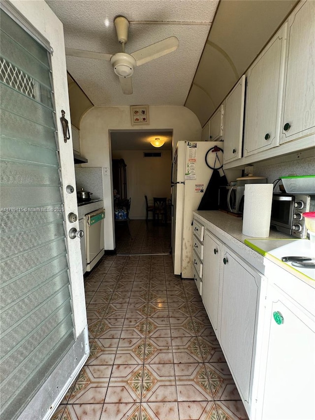 kitchen featuring a ceiling fan, light tile patterned floors, dishwasher, light countertops, and freestanding refrigerator