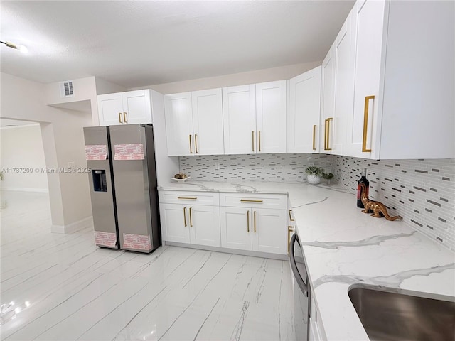 kitchen featuring backsplash, stainless steel fridge with ice dispenser, white cabinetry, and visible vents