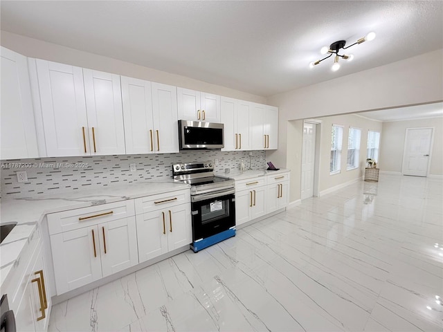 kitchen with backsplash, appliances with stainless steel finishes, marble finish floor, and white cabinets