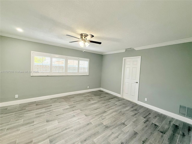 empty room with a ceiling fan, crown molding, a textured ceiling, light wood finished floors, and visible vents