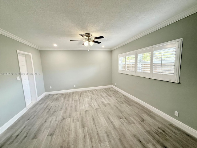 empty room with a ceiling fan, wood finished floors, a textured ceiling, and crown molding