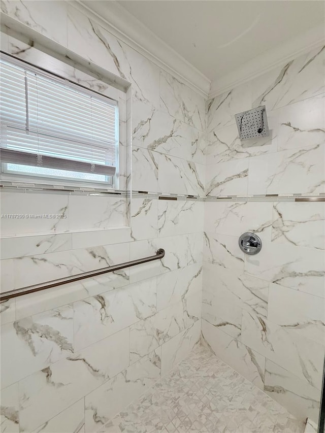 full bathroom with ornamental molding and tiled shower