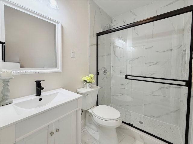 bathroom with toilet, vanity, and a marble finish shower