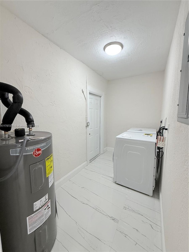clothes washing area with electric water heater, a textured ceiling, marble finish floor, a textured wall, and laundry area