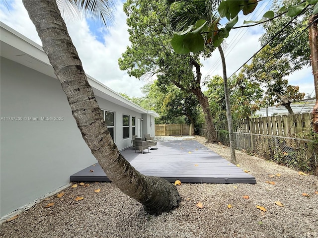 wooden deck featuring a fenced backyard