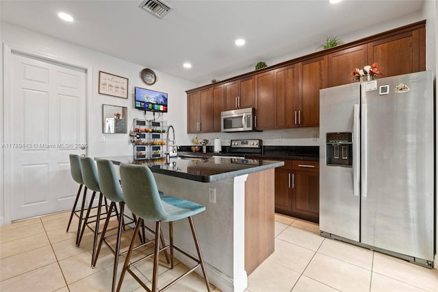 14637 SW 15th St, Pembroke Pines, FL 33027 - kitchen with appliances with stainless steel finishes, light tile patterned flooring, a sink, a kitchen island with sink, and recessed lighting