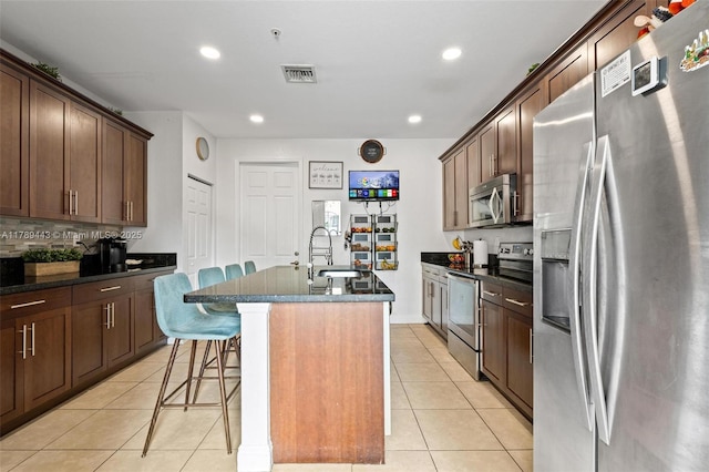14637 SW 15th St, Pembroke Pines, FL 33027 - kitchen with appliances with stainless steel finishes, light tile patterned floors, a sink, a kitchen island with sink, and a kitchen bar