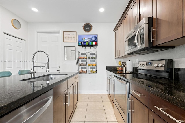 14637 SW 15th St, Pembroke Pines, FL 33027 - kitchen featuring stainless steel appliances, a sink, dark stone countertops, light tile patterned floors, and recessed lighting