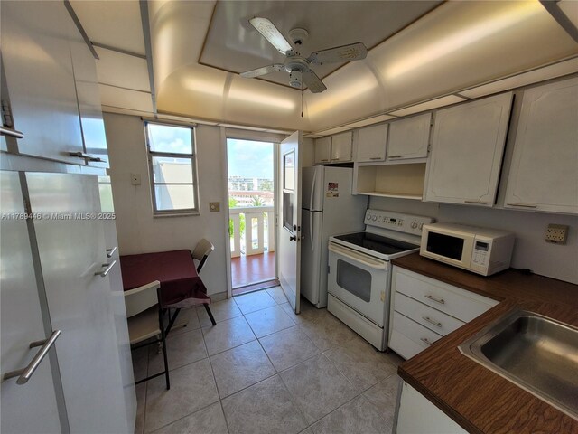 2930 Point E Dr Unit E603, Aventura, FL 33160 - kitchen with light tile patterned floors, a sink, ceiling fan, butcher block counters, and white appliances