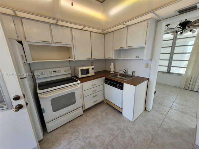 2930 Point E Dr Unit E603, Aventura, FL 33160 - kitchen with white appliances, open shelves, dark countertops, a sink, and visible vents