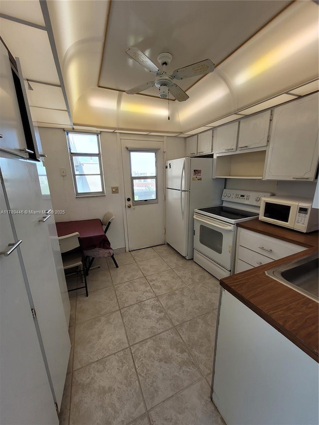 2930 Point E Dr Unit E603, Aventura, FL 33160 - kitchen with light tile patterned floors, a sink, ceiling fan, and white appliances