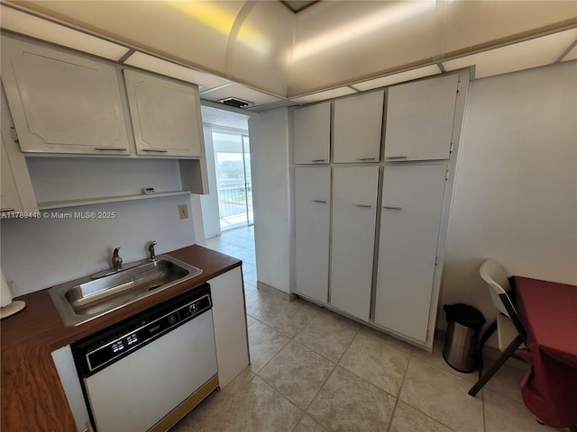 2930 Point E Dr Unit E603, Aventura, FL 33160 - kitchen with dark countertops, light tile patterned flooring, a sink, and white dishwasher