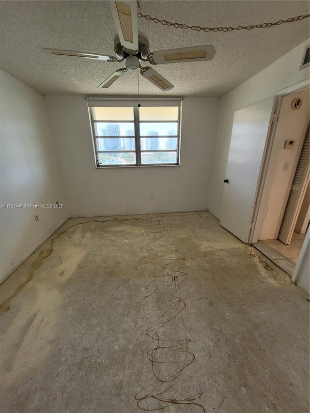 2930 Point E Dr Unit E603, Aventura, FL 33160 - unfurnished room featuring a textured ceiling and a ceiling fan