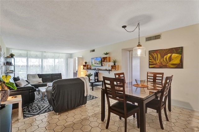 2671 S Course Dr Unit 409, Pompano Beach, FL 33069 - dining space featuring light tile patterned flooring, a textured ceiling, and visible vents