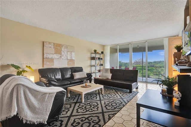 2671 S Course Dr Unit 409, Pompano Beach, FL 33069 - tiled living room featuring a wall of windows and a textured ceiling