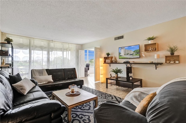 2671 S Course Dr Unit 409, Pompano Beach, FL 33069 - living room with a textured ceiling and visible vents