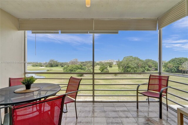 2671 S Course Dr Unit 409, Pompano Beach, FL 33069 - sunroom featuring golf course view and plenty of natural light