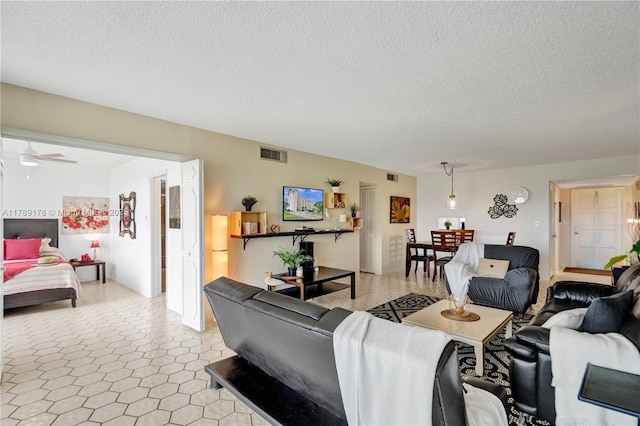 2671 S Course Dr Unit 409, Pompano Beach, FL 33069 - living room featuring visible vents, a textured ceiling, and ceiling fan