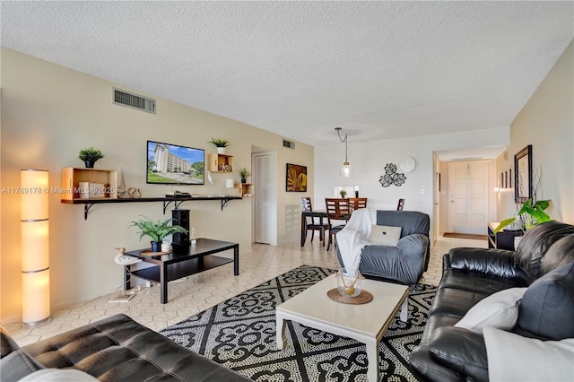 2671 S Course Dr Unit 409, Pompano Beach, FL 33069 - living room with a textured ceiling and visible vents