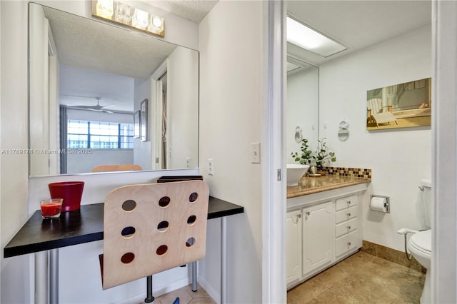 2671 S Course Dr Unit 409, Pompano Beach, FL 33069 - bathroom with a textured ceiling, toilet, baseboards, ceiling fan, and vanity