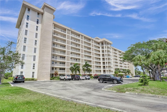 2671 S Course Dr Unit 409, Pompano Beach, FL 33069 - view of building exterior with uncovered parking