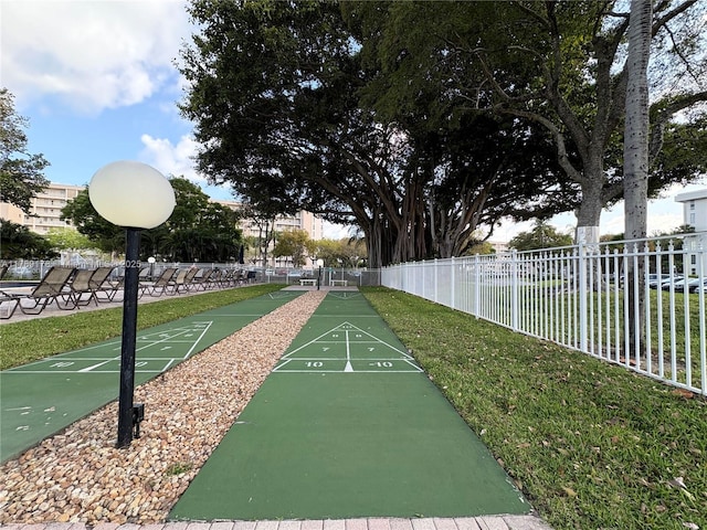 2671 S Course Dr Unit 409, Pompano Beach, FL 33069 - view of property's community with fence, a lawn, and shuffleboard