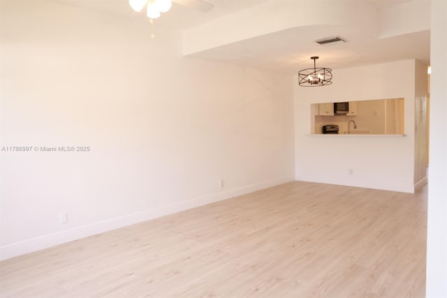 16686 Hemingway Dr Unit 16686, Weston, FL 33326 - spare room featuring ceiling fan with notable chandelier, baseboards, light wood-style flooring, and visible vents