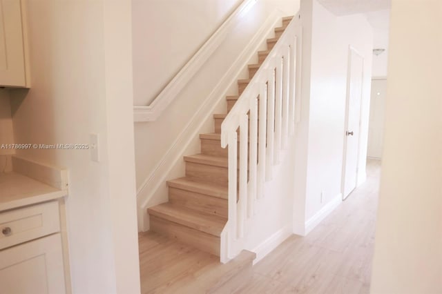 16686 Hemingway Dr Unit 16686, Weston, FL 33326 - staircase featuring baseboards and wood finished floors