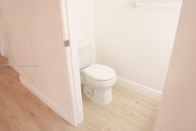 16686 Hemingway Dr Unit 16686, Weston, FL 33326 - bathroom featuring wood finished floors, toilet, and baseboards