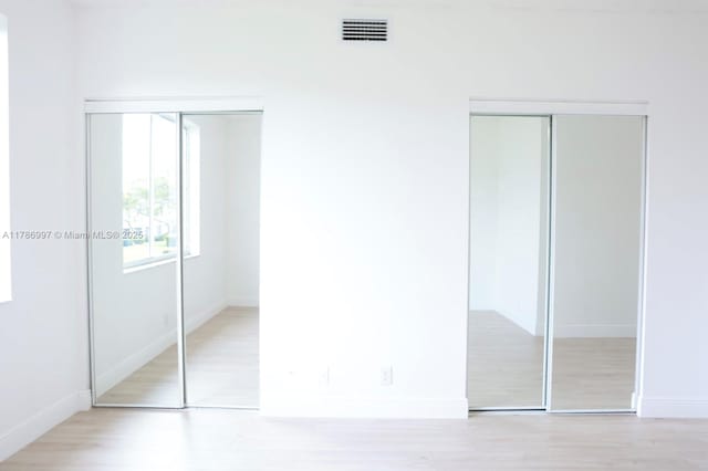 16686 Hemingway Dr Unit 16686, Weston, FL 33326 - unfurnished bedroom with baseboards, wood finished floors, and visible vents