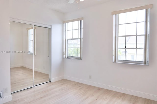 16686 Hemingway Dr Unit 16686, Weston, FL 33326 - unfurnished bedroom with ceiling fan, baseboards, light wood-style floors, and a closet
