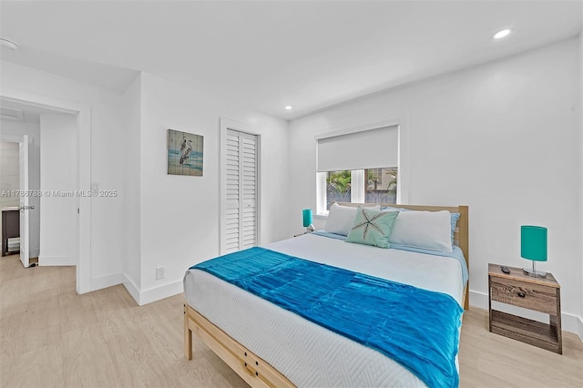 bedroom with baseboards, recessed lighting, light wood-style floors, and a closet