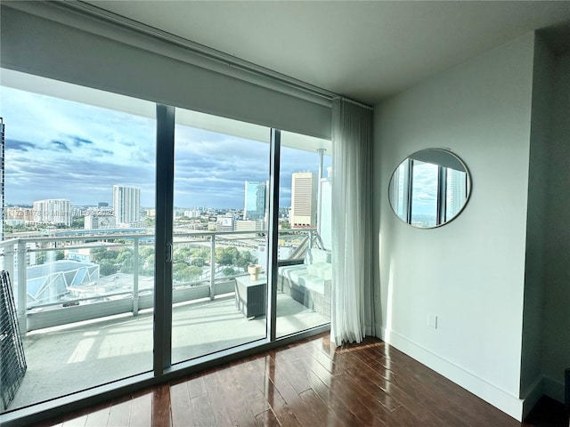 90 SW 3rd St Unit 2010, Miami, FL 33130 - spare room with a city view, baseboards, floor to ceiling windows, and dark wood finished floors