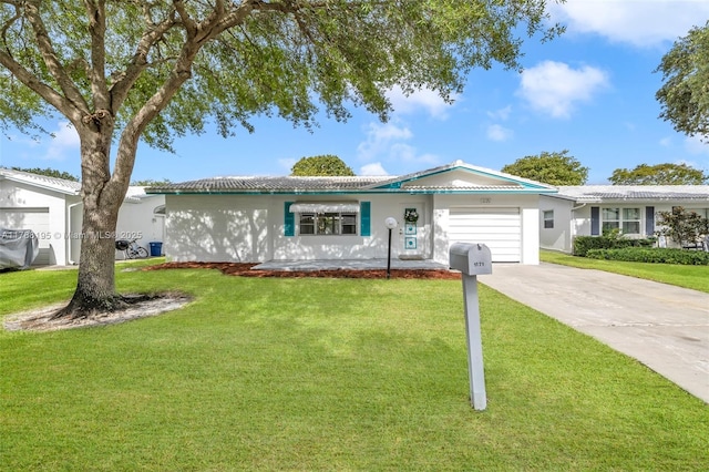 ranch-style home featuring a garage, stucco siding, a front yard, and concrete driveway