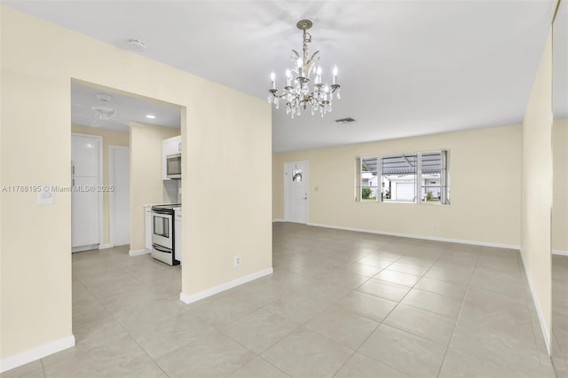 empty room with visible vents, baseboards, a notable chandelier, and light tile patterned floors