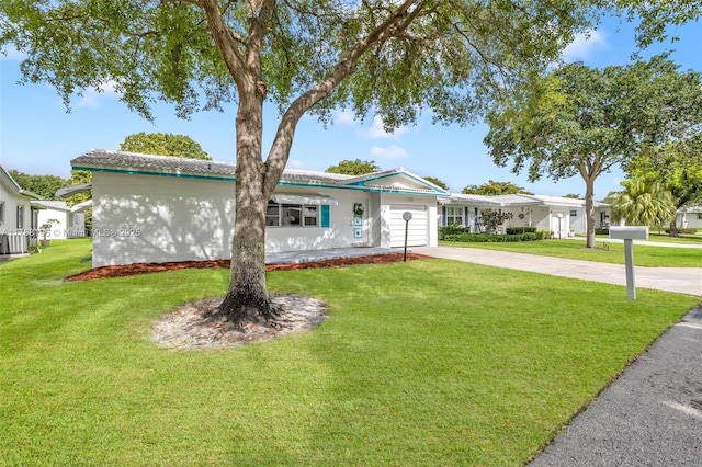 single story home with a garage, a front lawn, central air condition unit, and concrete driveway