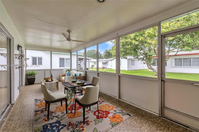 sunroom / solarium featuring ceiling fan