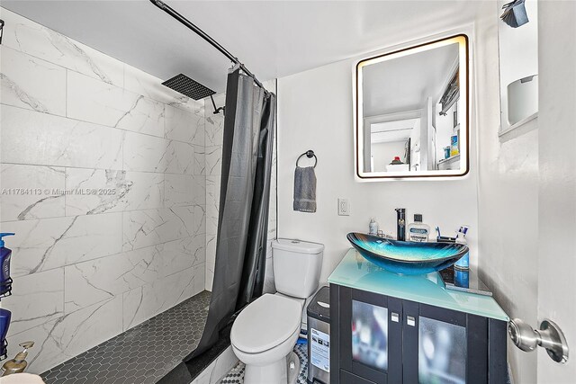 4500 N Flagler Dr Unit C24, West Palm Beach, FL 33407 - full bathroom featuring toilet, tiled shower, and vanity