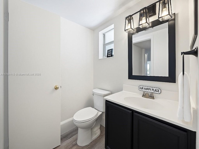 4500 N Flagler Dr Unit C24, West Palm Beach, FL 33407 - bathroom with vanity, toilet, wood finished floors, and baseboards