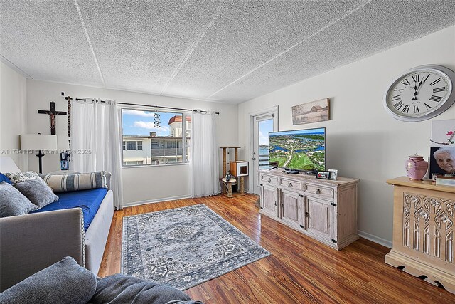 4500 N Flagler Dr Unit C24, West Palm Beach, FL 33407 - living area featuring wood finished floors and a textured ceiling