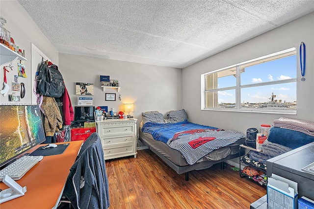 4500 N Flagler Dr Unit C24, West Palm Beach, FL 33407 - bedroom featuring wood finished floors and a textured ceiling