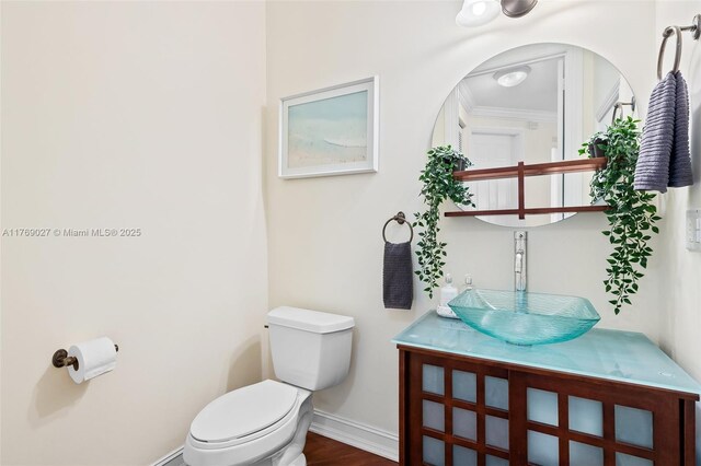 419 SW 5th St Unit 419, Fort Lauderdale, FL 33315 - bathroom with ornamental molding, vanity, and wood finished floors