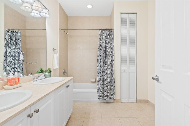 full bath with tile patterned floors, double vanity, a sink, shower / tub combo with curtain, and a closet