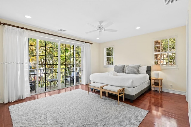 bedroom featuring baseboards, a ceiling fan, wood finished floors, and visible vents