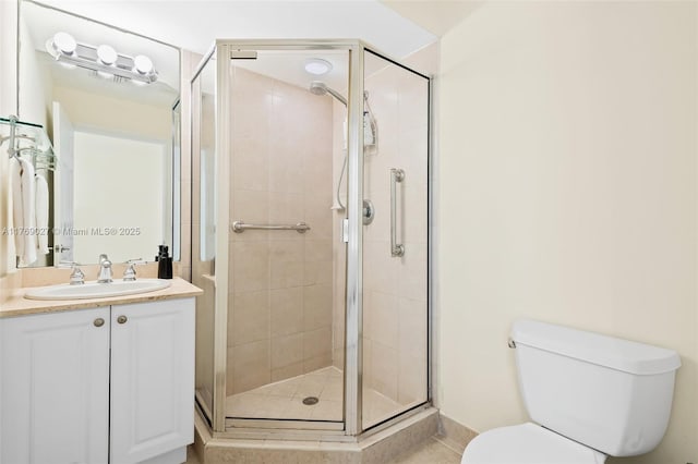 full bath with tile patterned flooring, vanity, toilet, and a stall shower