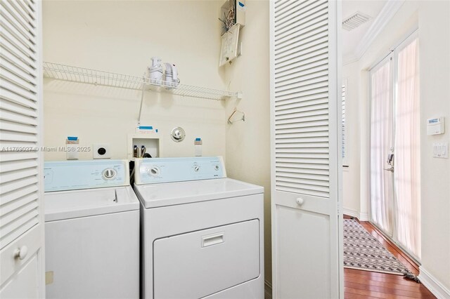 419 SW 5th St Unit 419, Fort Lauderdale, FL 33315 - laundry room featuring washer and dryer and dark wood finished floors