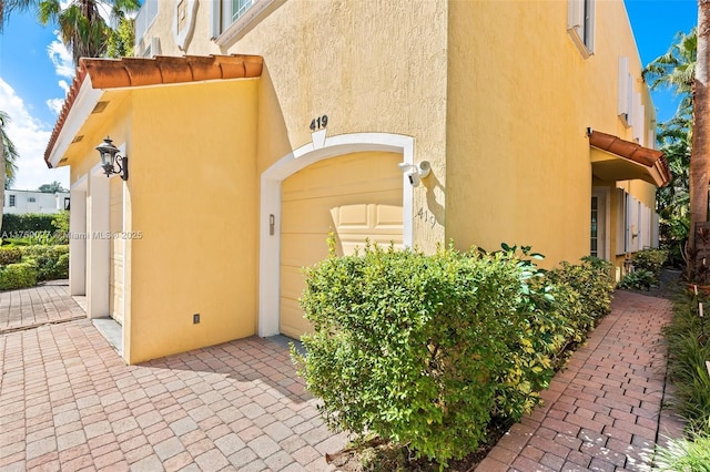 doorway to property featuring stucco siding