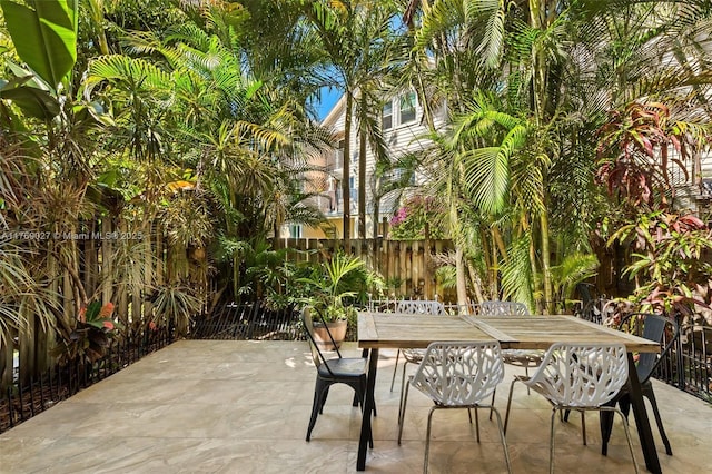 view of patio featuring outdoor dining area and fence